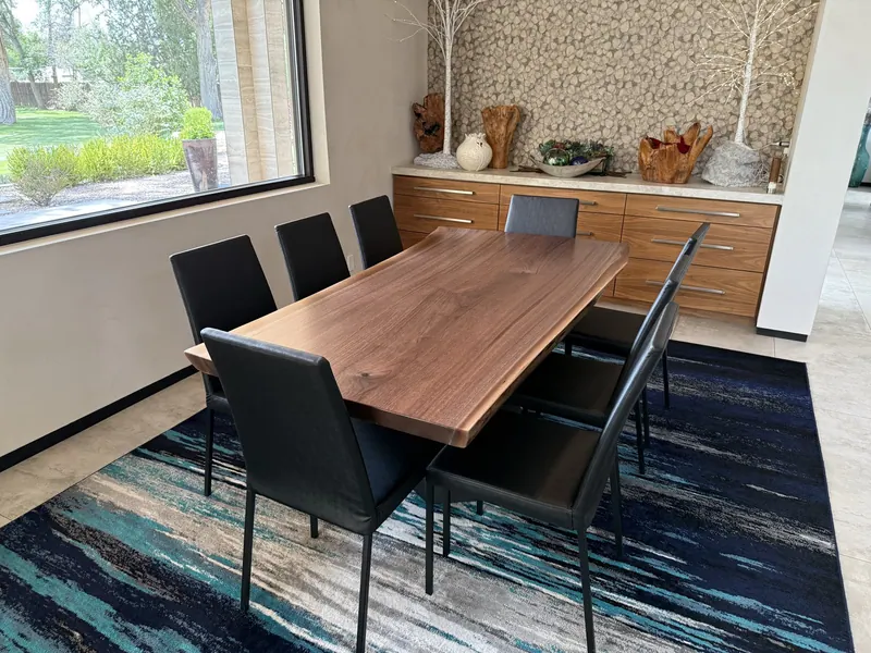 Wood dining tabletop in a bright interior.